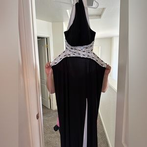 Black and white floor length, high slit prom dress with silver detailing.